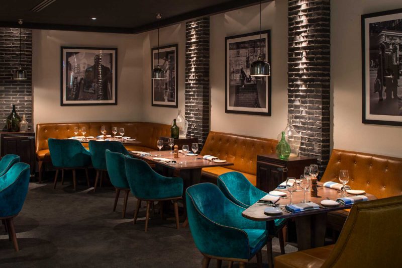 The back dining room at The Bourbon features photographs by Vivian Maier, design by Paul Kelly Design