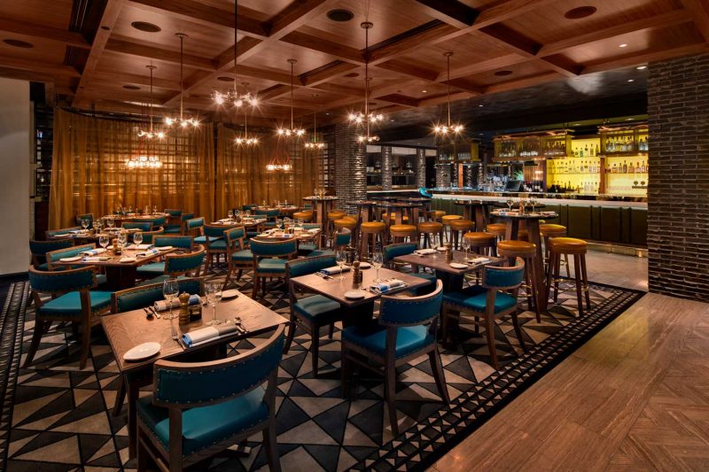 Dining room with detailed tiled floor at The Bourbon, design by Paul Kelly Design