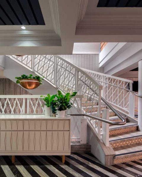 Staircase with light Hamptons feel at The Ivanhoe Hotel interior design by Paul Kelly Design