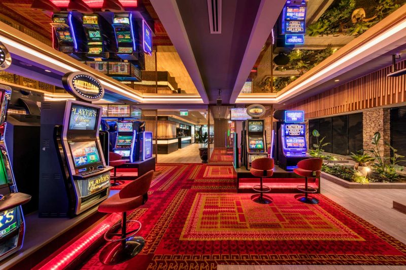 Gaming room at Riverwood showing the indoor garden alongside gaming machines, design by Paul Kelly Design