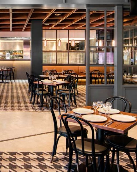 Groups of tables and ceiling detail in this photo of St Johns Park by Paul Kelly Design