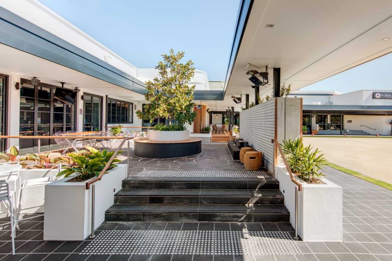 Exterior wide view of St Johns Park showing tiled surfaces and plantings by Paul Kelly Design