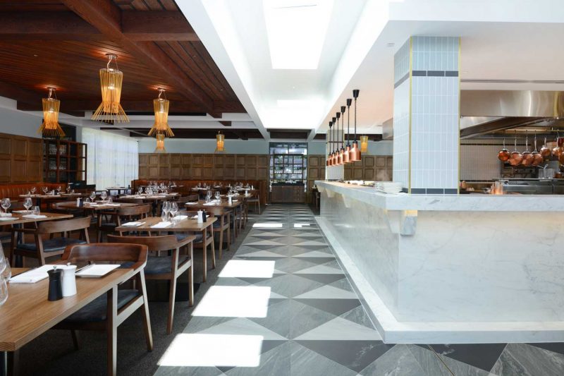 Marble bar, tiled floor and seating arrangement at The Workshop, design by Paul Kelly Design